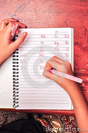 Child writing alphabet Stock Photo