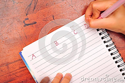 Child writing alphabet Stock Photo