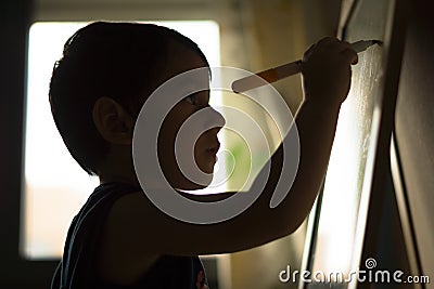 Child writing on a blackboard Stock Photo