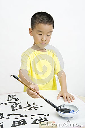 A child writing Chinese Calligraphy Stock Photo