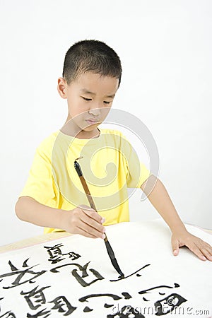 A child writing Chinese Calligraphy Stock Photo