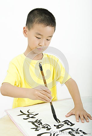 A child writing Chinese Calligraphy Stock Photo