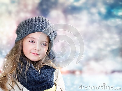 Child's girl portrait on blurred winter background. Stock Photo