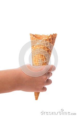 Child& x27;s little hand holding empty waffle cornet isolated on white background Stock Photo