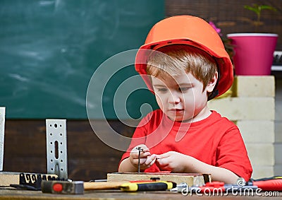 Childhood concept. Boy play as builder or repairer, work with tools. Child dreaming about future career in architecture Stock Photo