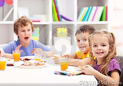 Childhood friends eating together Stock Photo