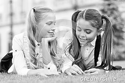 Childhood friends. Happy children relax on green grass. Happy childhood. Enjoying childhood years. Childhood protection Stock Photo