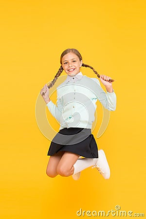 Childhood happiness. Kid cute student. Schoolgirl excellent pupil jump mid air. Schoolgirl tidy appearance school Stock Photo