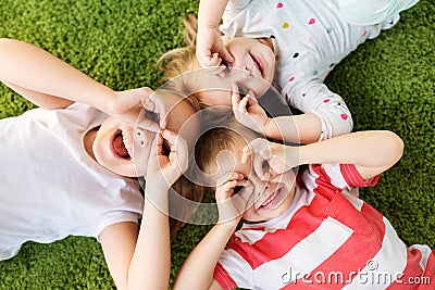 Happy little kids looking through finger glasses Stock Photo