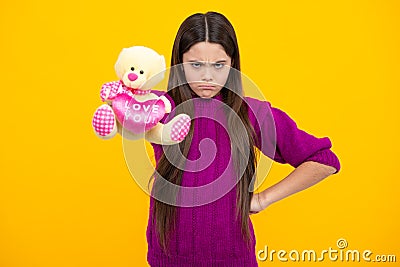Childhood, toys and kids. Cute teen girl cuddling fluffy toy. Angry teenager girl, upset and unhappy negative emotion. Stock Photo