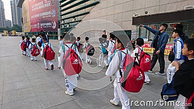 Shenzhen, China: children athletes walk past the sports square to take part in a competition Editorial Stock Photo