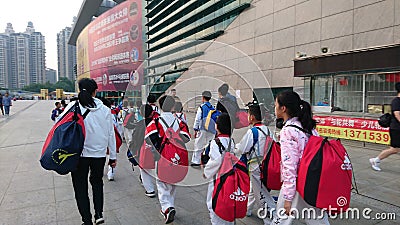 Shenzhen, China: children athletes walk past the sports square to take part in a competition Editorial Stock Photo