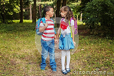 Children with backpacks. Boy and girl are friends. Back to school. The concept of education, school, childhood Stock Photo