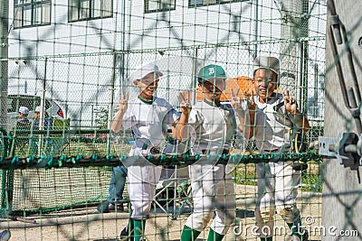 Children at a baseball field in the schoolyard in Osaka, Japan Editorial Stock Photo