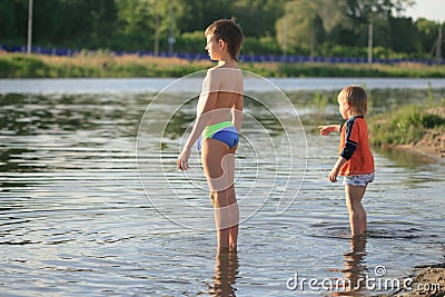 Children bathe in the evening on the city beach Stock Photo