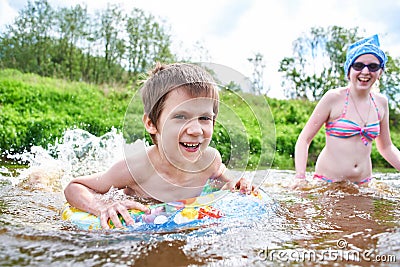 Children bathes in river on summer day Stock Photo