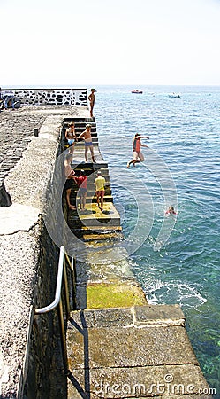 Children bathing in the port of Arrieta in Lanzarote Editorial Stock Photo