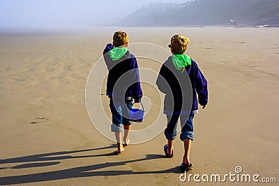 Children on Beach. Backs to Camera. Cannon Beach. Stock Photo