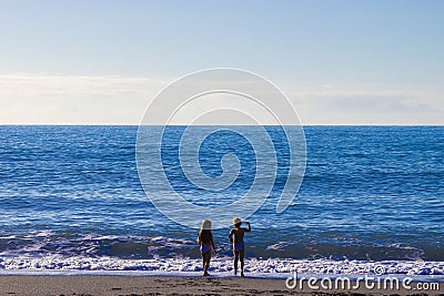 Children on the Beach. Two Unrecognizable Girls on the Background of the Turquoise Water of the Ocean. Family Walk in the Fresh Editorial Stock Photo