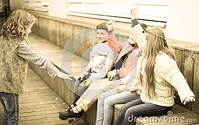 Children on bench playing children`s games Stock Photo