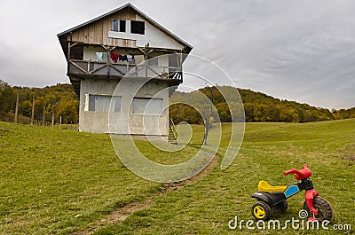 Children bike near unfinished house Stock Photo