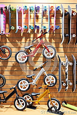 Children bikes and skateboards in sport store Stock Photo