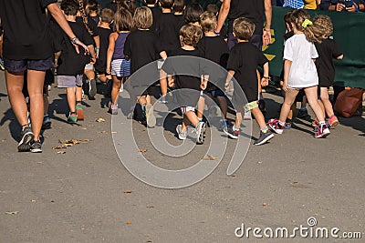 Children with Black Shirt Running in the Park with Young Teacher Editorial Stock Photo