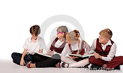 children with books siiting on the floor Stock Photo