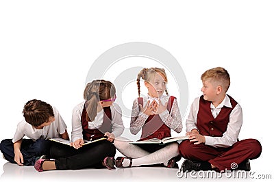 children with books siiting on the floor Stock Photo