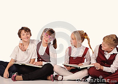 children with books siiting on the floor Stock Photo