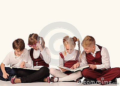 children with books siiting on the floor Stock Photo