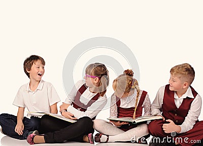 children with books siiting on the floor Stock Photo