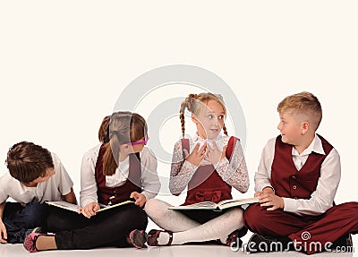 children with books siiting on the floor Stock Photo