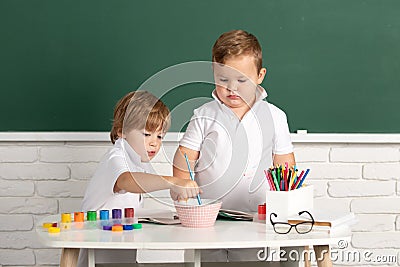 Children boys draws with paints. Kids artist creativity. Little artist painting, drawing art. Stock Photo