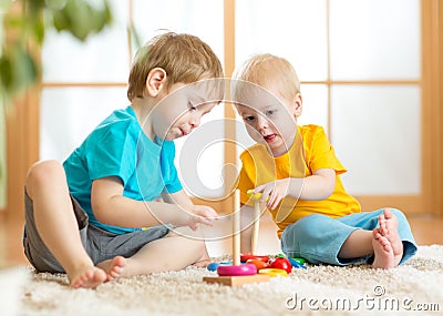 Children boys with toys in playroom Stock Photo