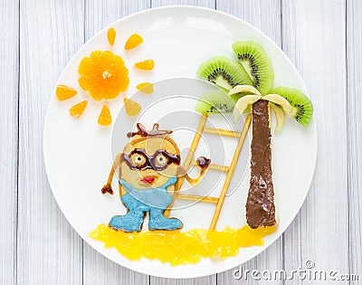 Children breakfast with pancakes and fruits. Cartoon hero. Stock Photo