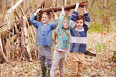 Children Building Camp In Forest Together Stock Photo