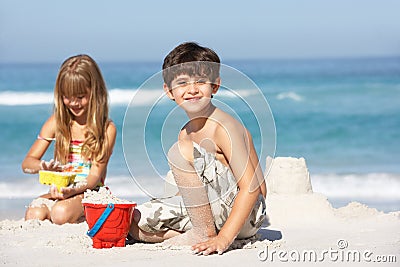 Children Building Sandcastles On Beach Holiday Stock Photo