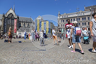 Children catch soap bubbles in the central Dam Square in Amsterdam Editorial Stock Photo