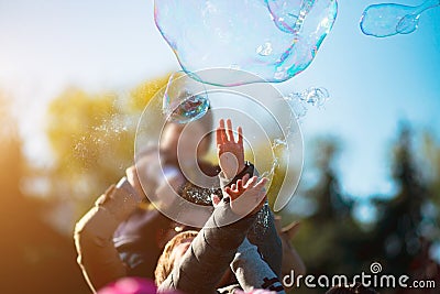 Children catch soap bubbles with their hands at a street party Stock Photo