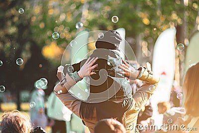 Children catch soap bubbles with their hands at a street party Stock Photo