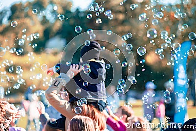 Children catch soap bubbles with their hands at a street party Stock Photo