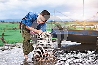 Children catching fish and have fun in the canal. Life style of children Stock Photo