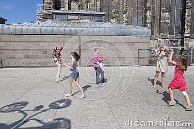 Children catching soap bubbles in the street near of the Cologne Cathedral Editorial Stock Photo