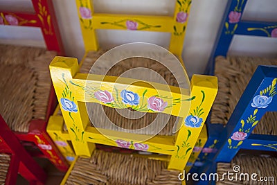 Children chairs painted with bright colors. Alentejo crafts Editorial Stock Photo