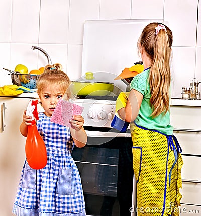 Children cleaning kitchen. Stock Photo
