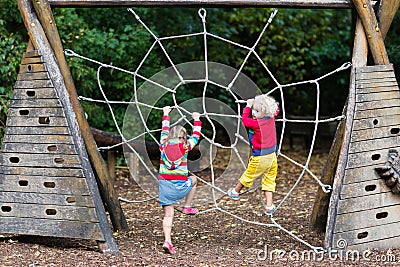 Children climb on school yard playground Stock Photo