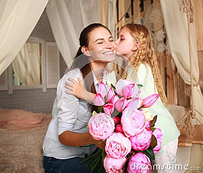 Children congratulate mother give her bouquet of flowers Stock Photo