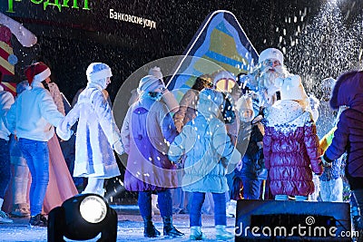 Children dance in a circle on the stage. New Year's performance Editorial Stock Photo