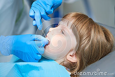 Children dentistry. Liitle girl an dentist examination, teeth cleaning and treatment. Stock Photo